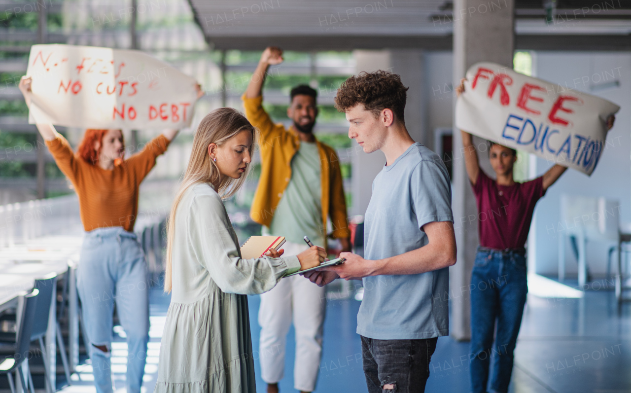University students activists protesting indoors at school, fighting for free education concept.