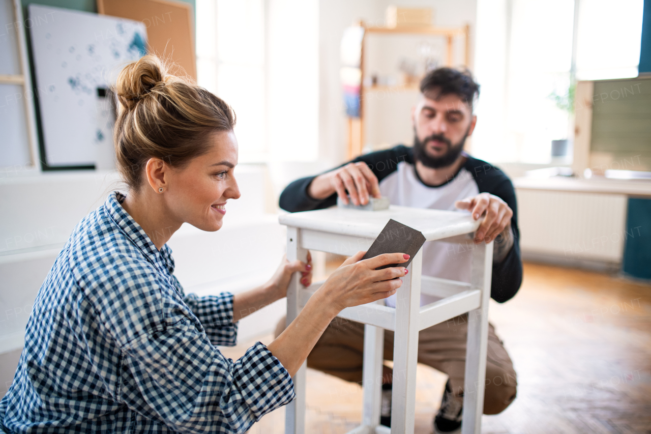Happy mid adults couple renovating furniture indoors at home, relocation and diy concept.