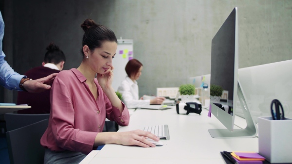 A group of young businesspeople working together in office, talking.