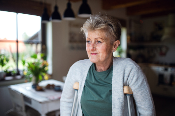 Portrait of a senior woman reconvalestenting indoors at home, looking aside.