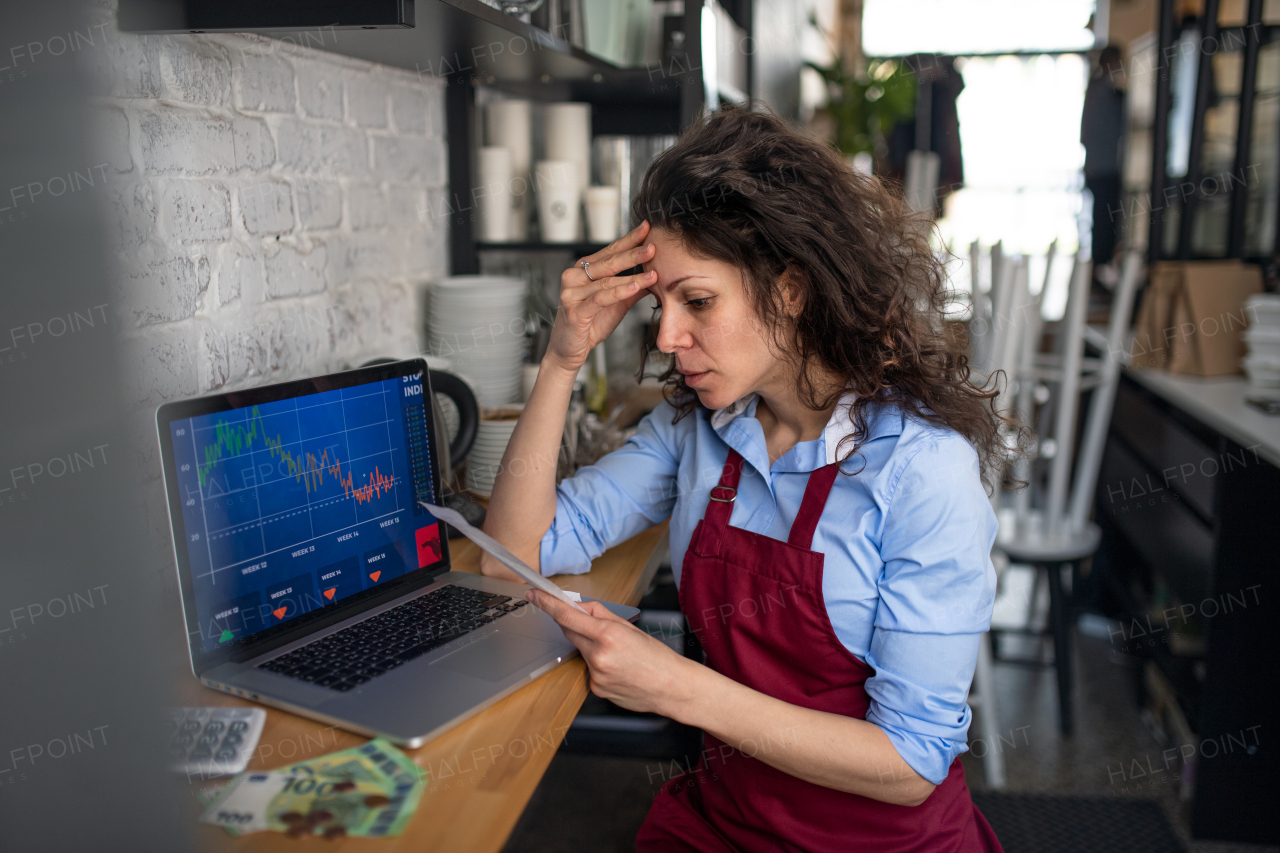 A frustrated coffee shop manager discussing issues with waitress in cafe, small business and new normal concept.