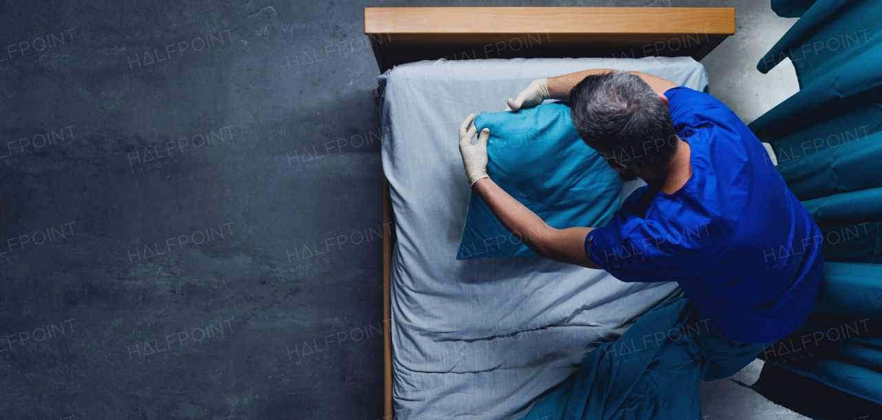 Healthcare worker doing on bed in hospital, coronavirus concept. Copy space.