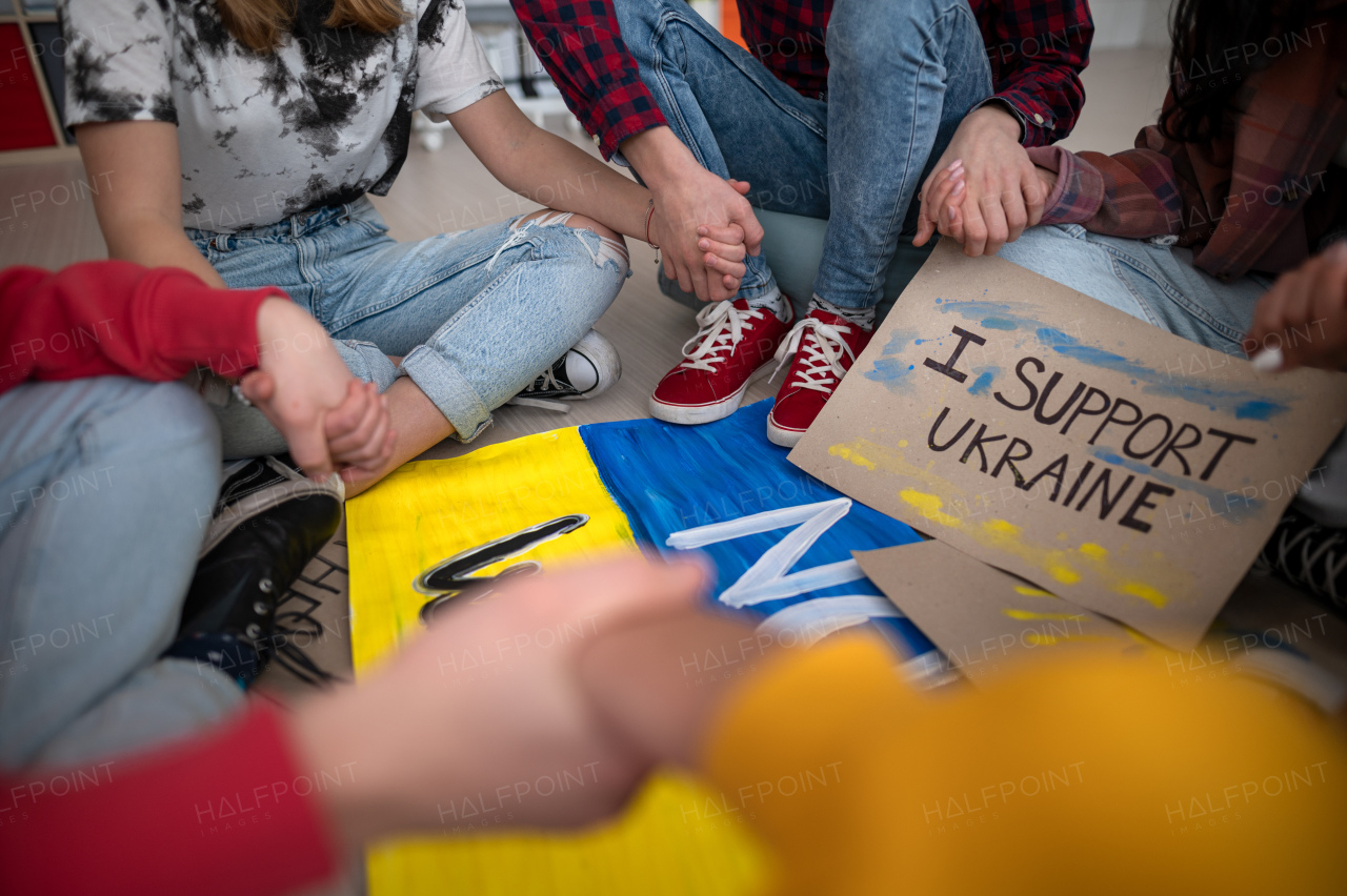 A close-up of students praying for Ukraine at school.