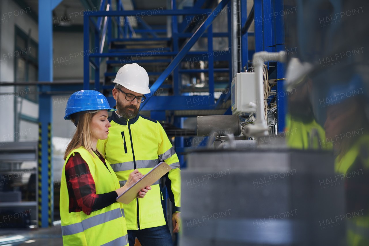 Female engineering manager and mechanic worker inside the factory