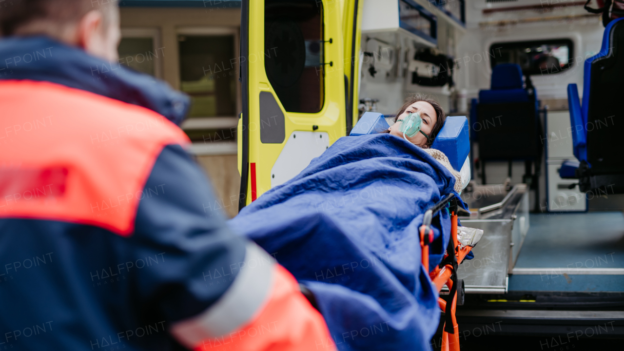 Rescuer taking care of a patient, preparing her for transport.