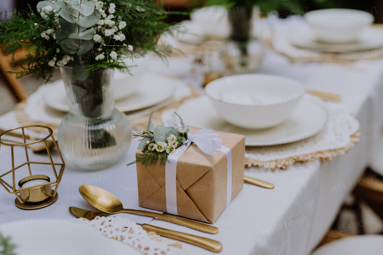 High angle view of wedding gift wrapped in an eco paper papckaging and flower decoration.