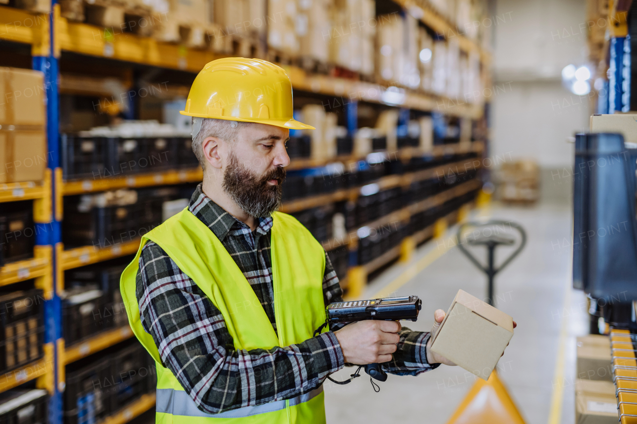 Warehouse worker checking up stuff in warehouse.
