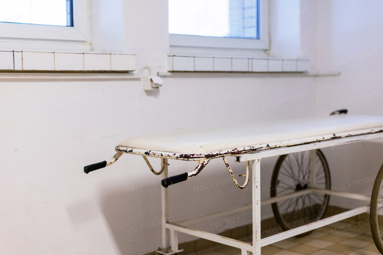 Close up of hospital stretcher with wheels. Outdated vintage hospital gurney in the hospital corridor.