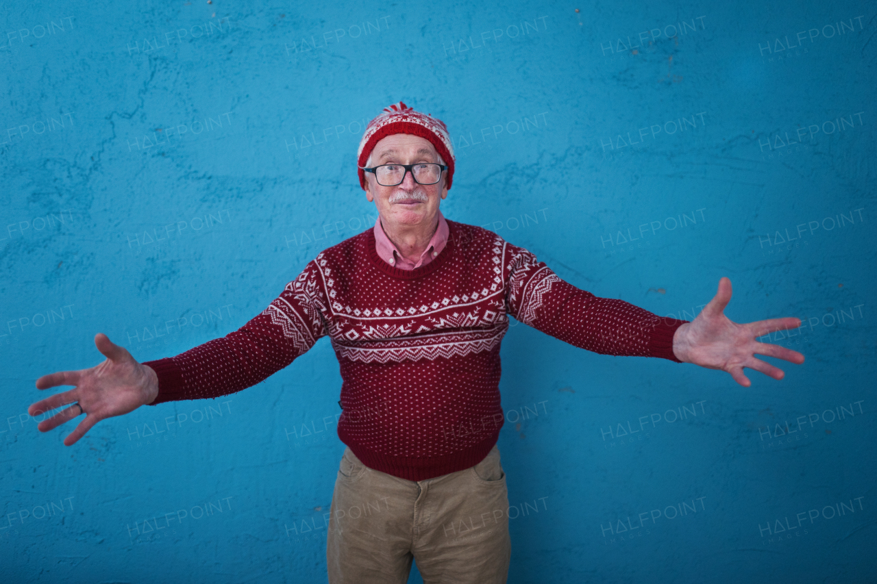 Portrait of happy, excited senior man in Chrstimas sweater.