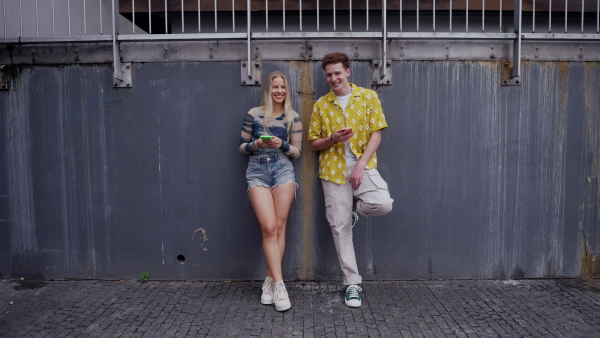 Video of generation z couple spending time outdoors in the city online. Students spending free time online, watching social media content. Concept of gen Z as loneliest generation.