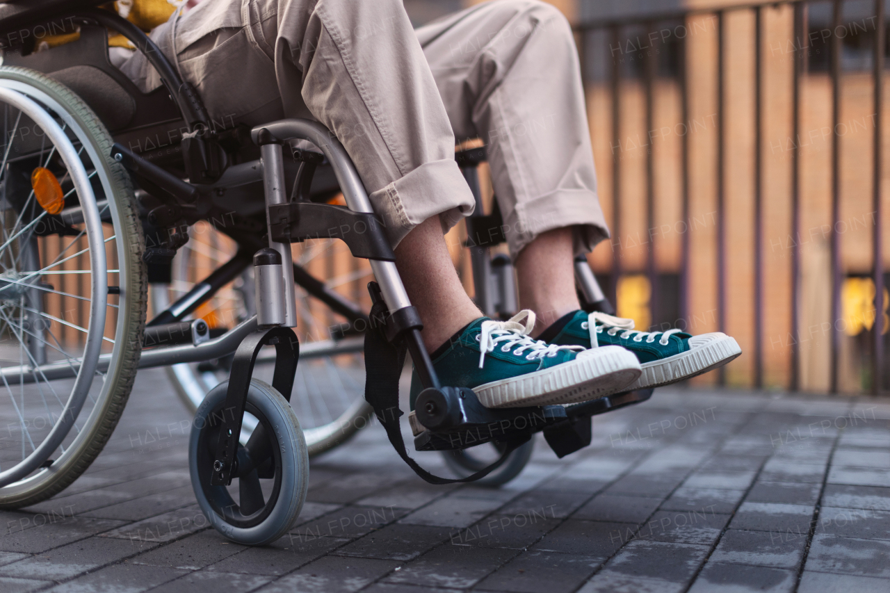 Close up of young gen Z boy in a wheelchair in the city. Inclusion, equality, and diversity among Generation Z.