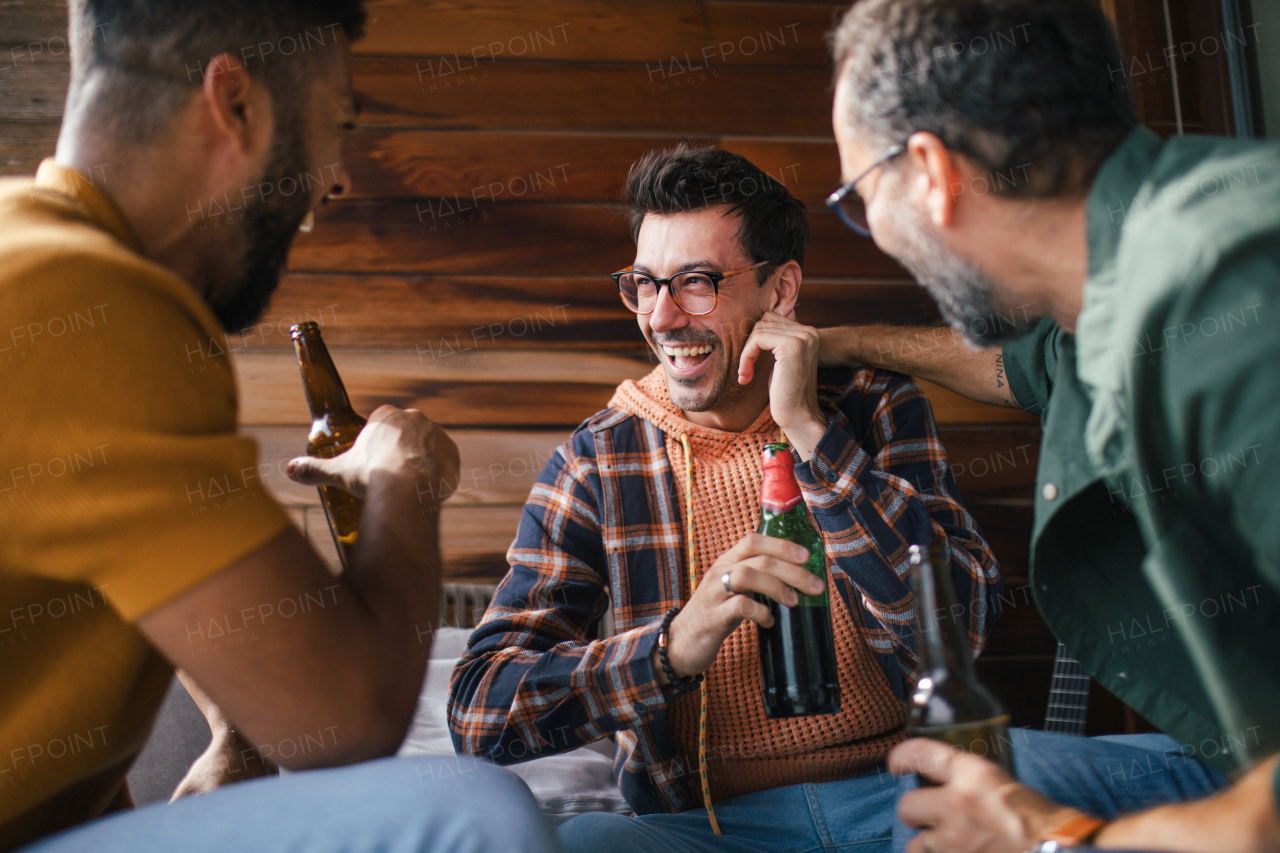 Best friends togehter, drinking beer and talking, having fun and laugh. Concept of male friendship, bromance.