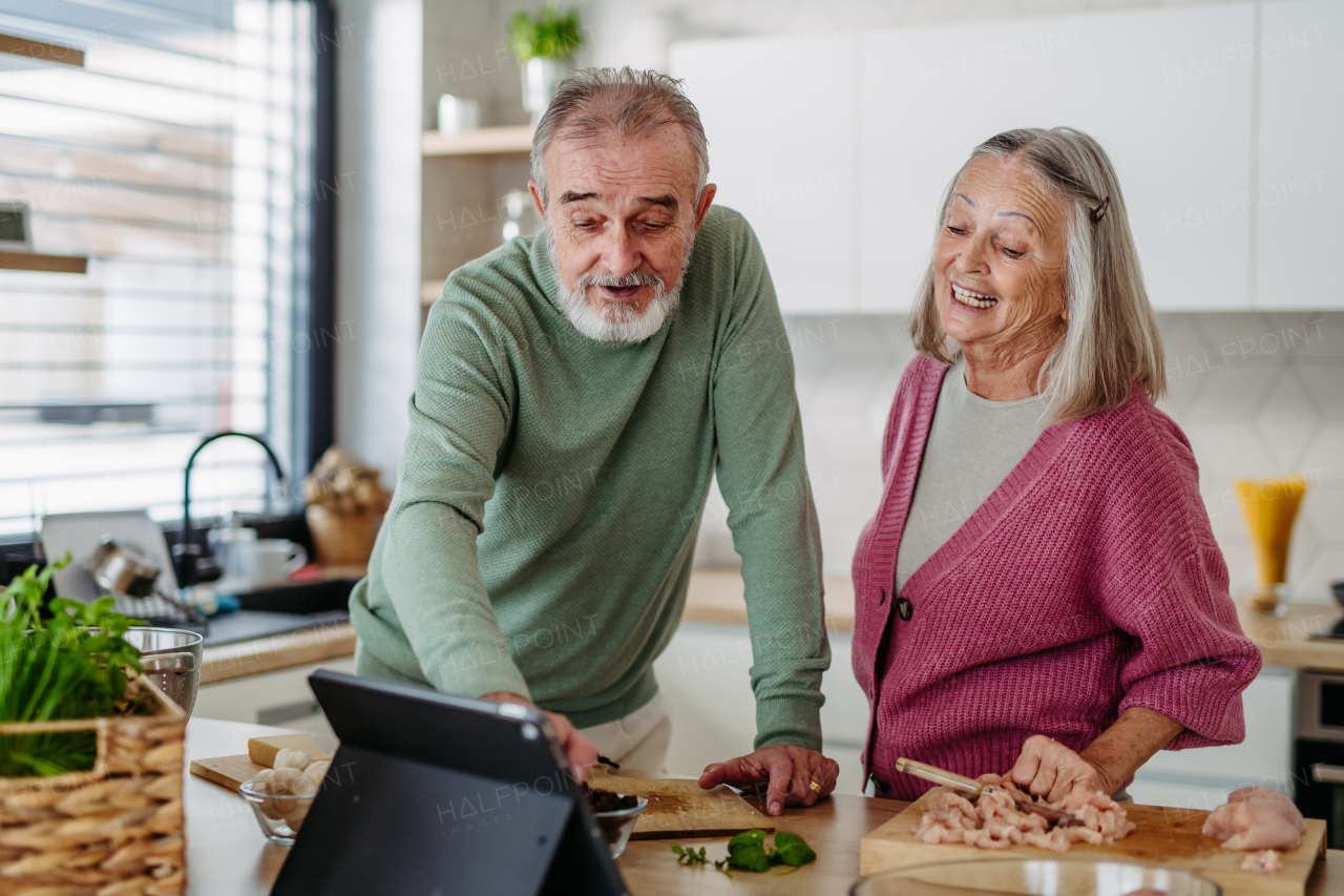 Senior couple cooking together in the kitchen.