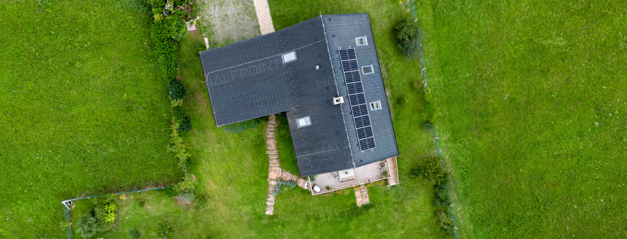 Top view of solar photovoltaic panels on a roof, alternative energy, saving resources and sustainable lifestyle concept.