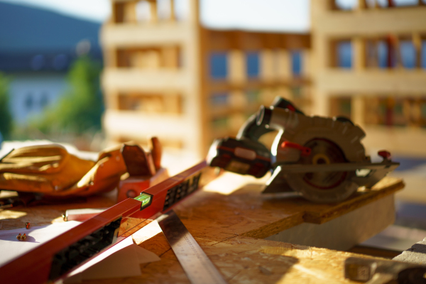 Close up of a construction tools inside of unfinished wooden house.
