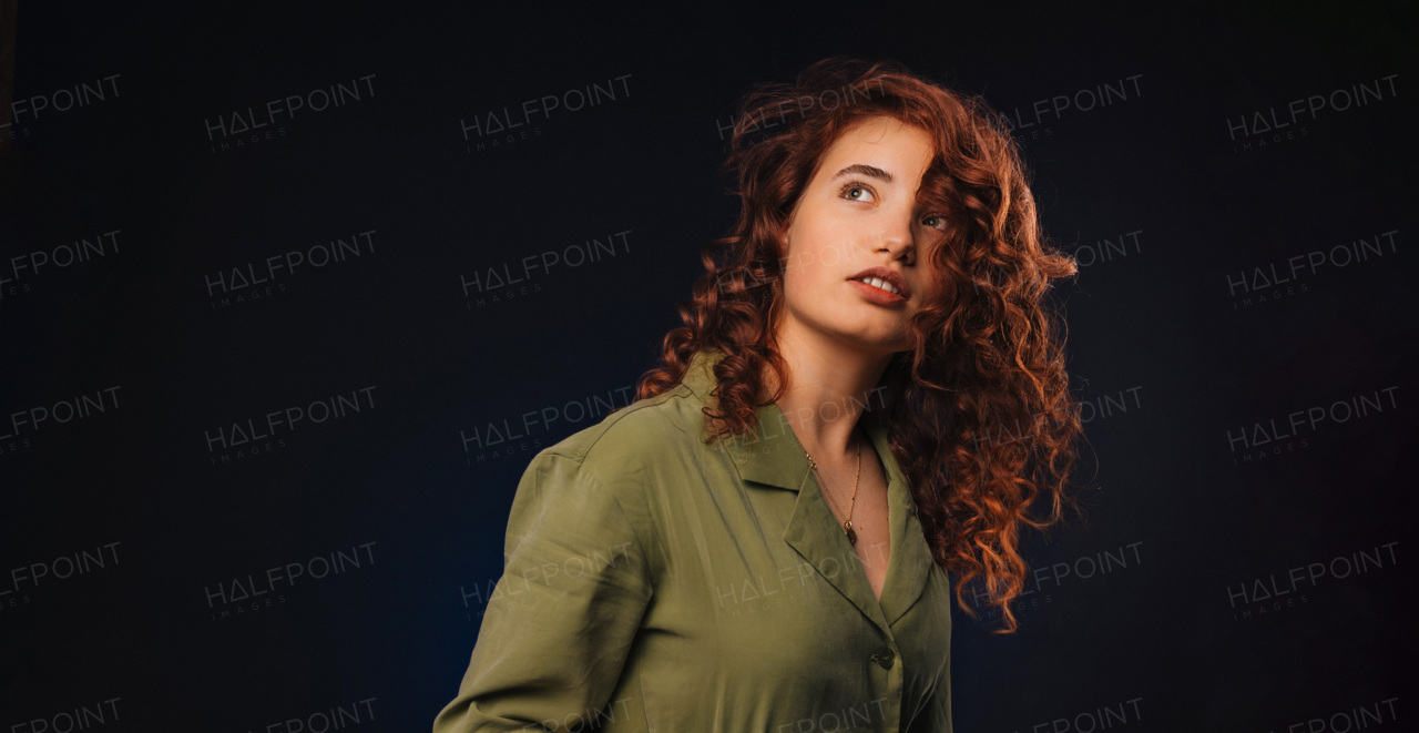 Portrait of a young redhead woman, studio shoot.
