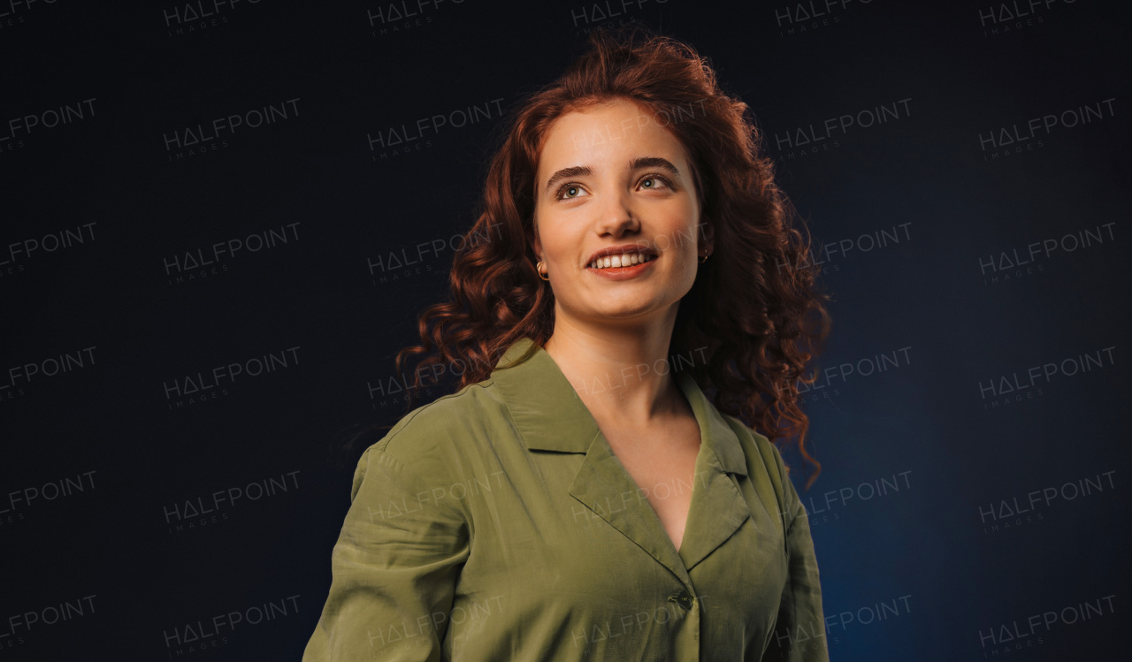 Portrait of a young redhead woman, studio shoot.
