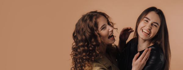 Portrait of two young happy friends, studio shoot,