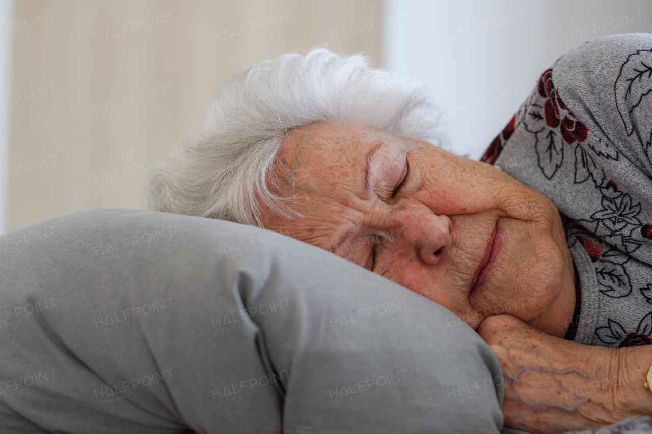 Senior woman sleeping in her bed alone, feeling anxious. Loneliness and social isolation of eldery woman.