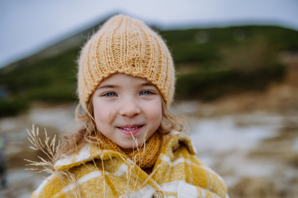 Portrait of little girl during autumn hike in the mountains.