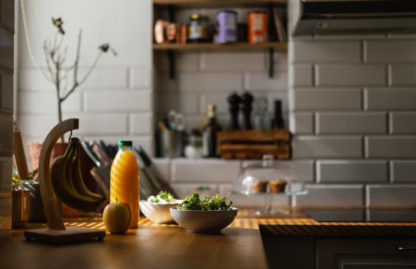 Close up of kitchen with a salad and juice.