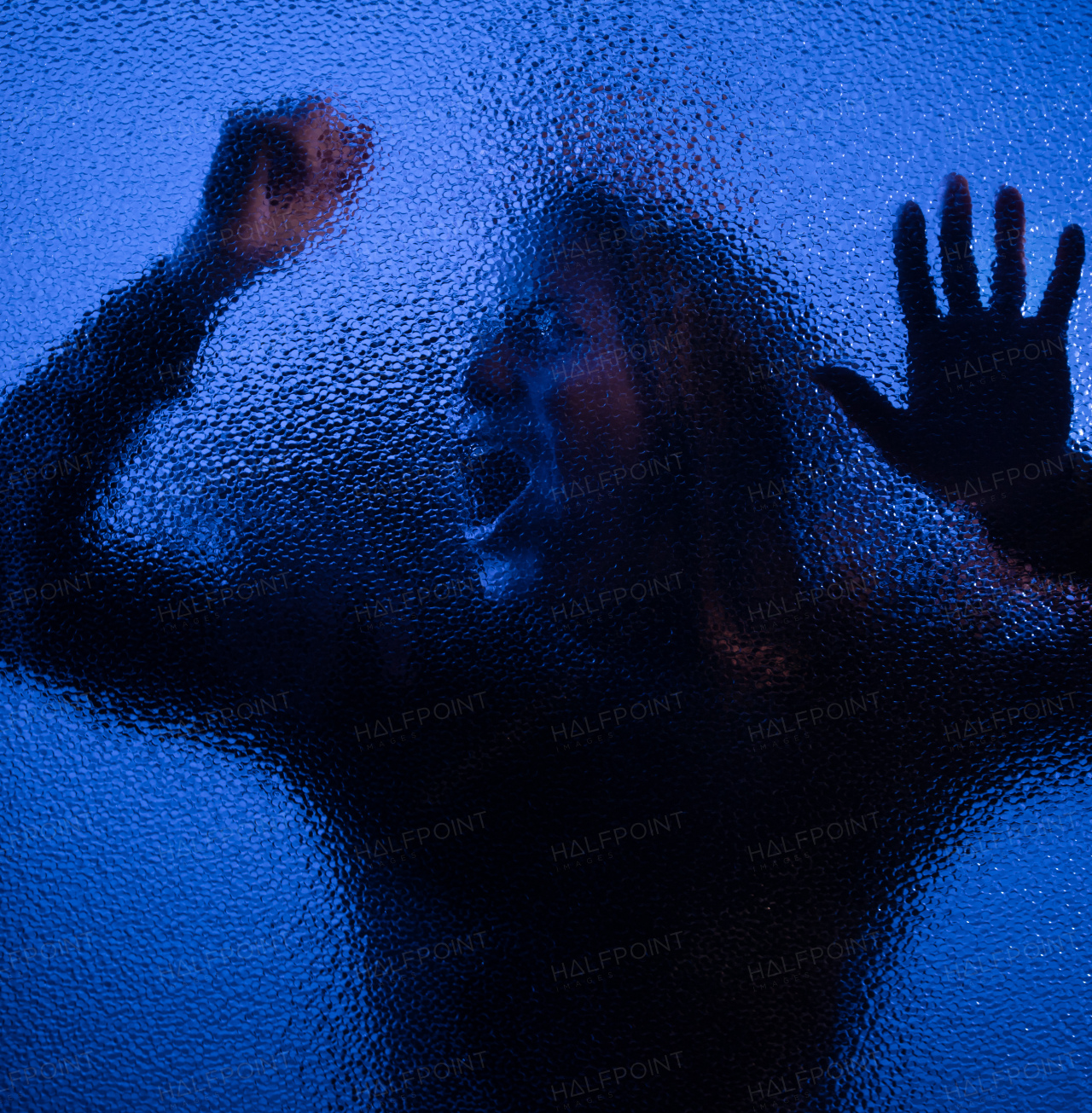 The shadow of woman screaming behind the glass, domestic violence concept.