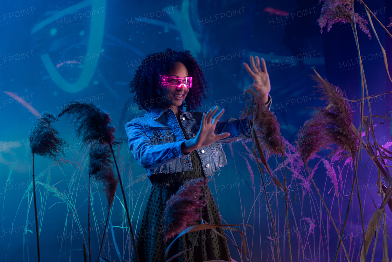 Metaverse digital cyber world technology, a woman with virtual reality VR goggles playing augmented reality game, futuristic lifestyle
