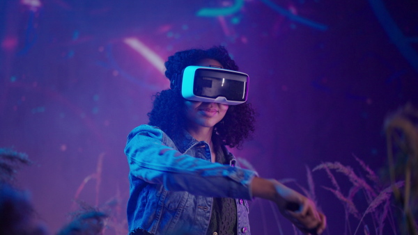 Metaverse digital cyber world technology, girl with virtual reality VR goggles playing augmented reality game, futuristic lifestyle