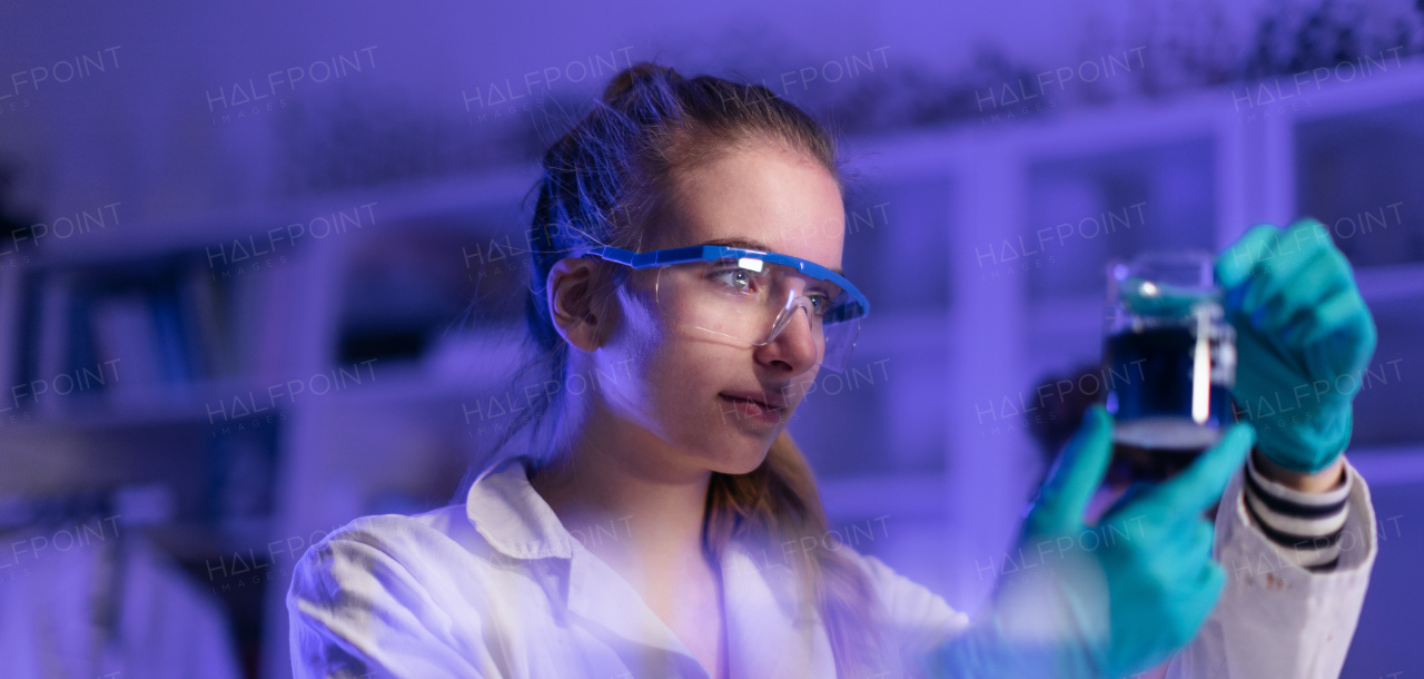 A science student doing chemical experiment in the laboratory at university.