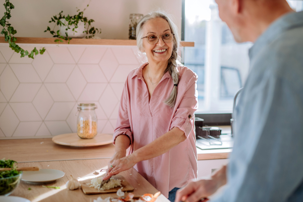 A senior couple cooking together at home.