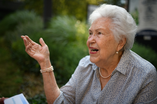 Portrait of beautiful old, senior lady talking.