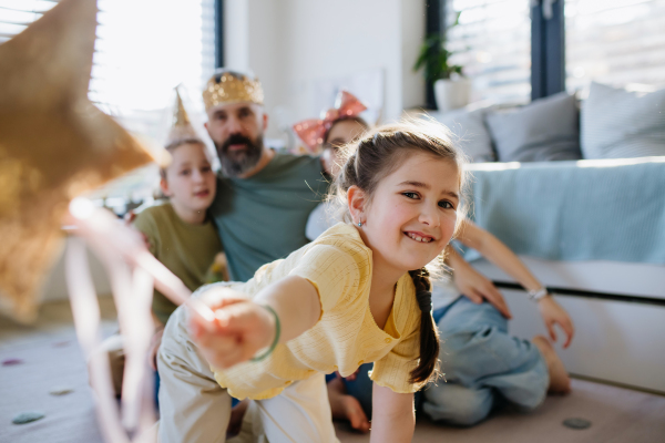 Portrait of father with three daughters at home. Girl dad concept.