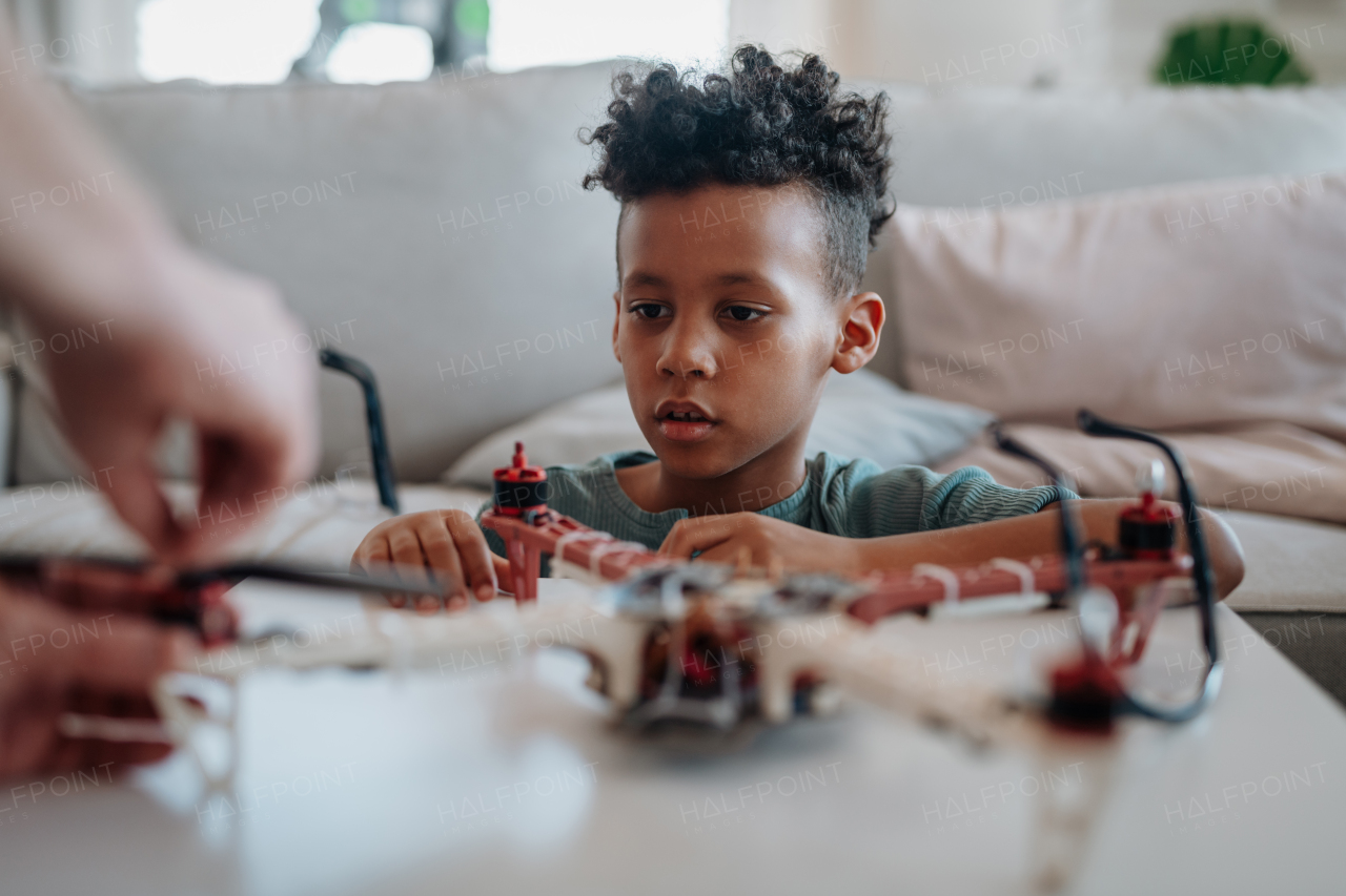 Father teaching son about STEM, robotics, and discussing technology at home.