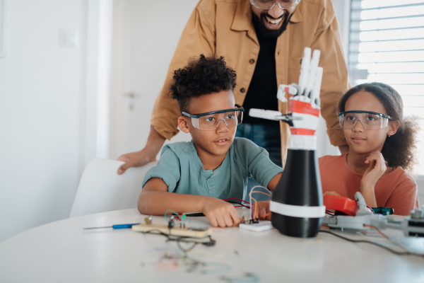 Parents encouraging children to explore a robotics and technical skills.