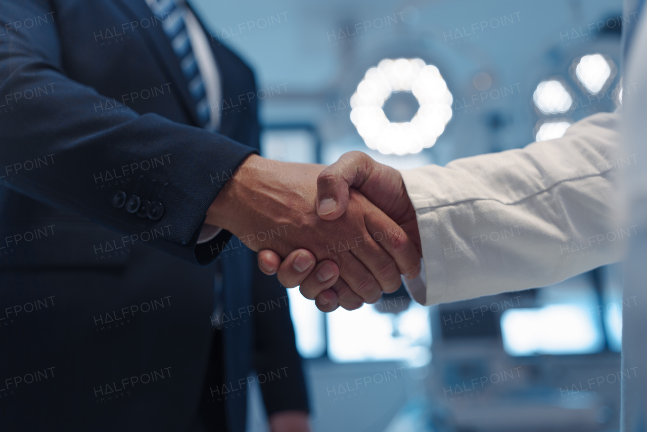 Hospital business handshake in medical environment. Strategic collaboration in medical industry.