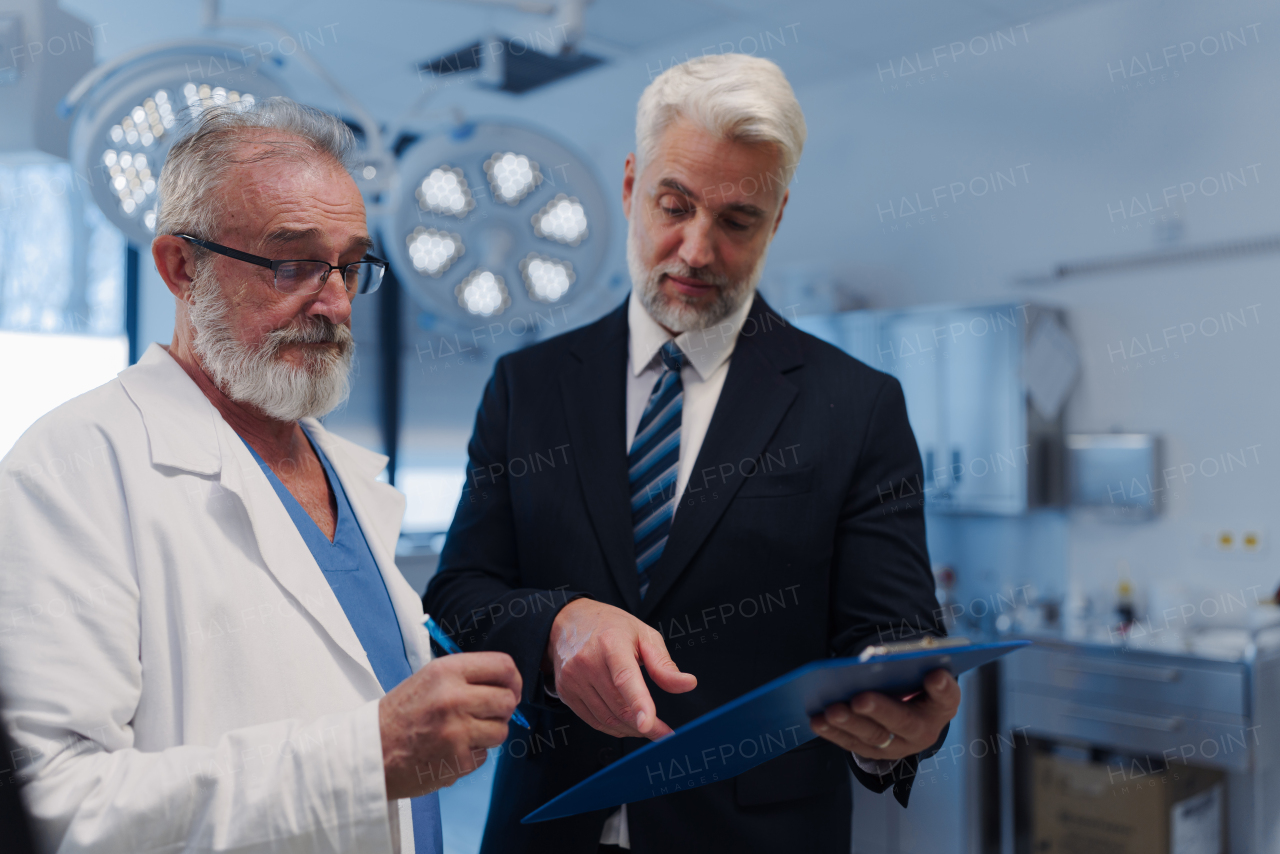 Doctor talking with pharmaceutical representative, hospital setting.