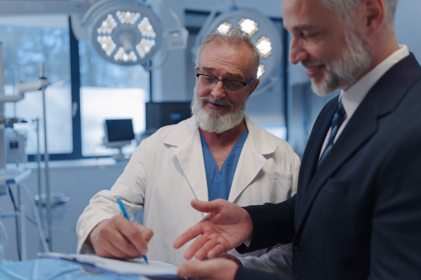 Doctor signing contract with pharmaceutical representative, successful deal.