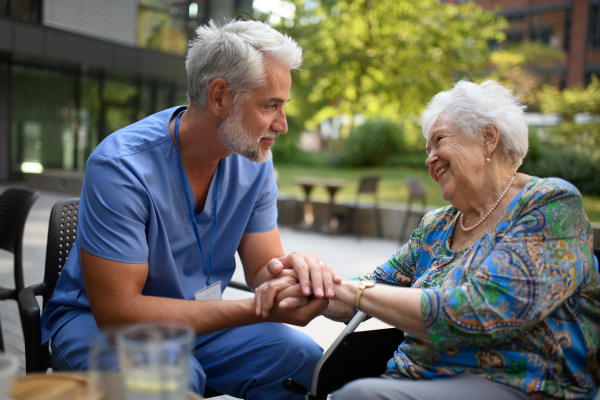 Healthcare worker listening to senior patients problems. Concept of emotional support.