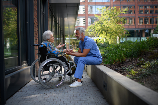 Healthcare worker listening to senior patients problems. Concept of emotional support.