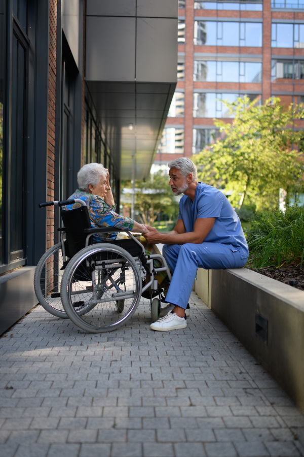 Healthcare worker listening to senior patients problems. Concept of emotional support.