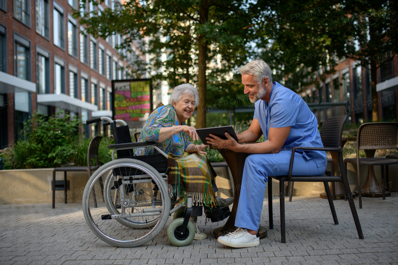Doctor explaining medication to senior patient and answering her questions about diagnosis.