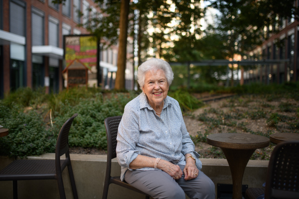 Portrait of beautiful old, senior lady sitting outdoors in park.
