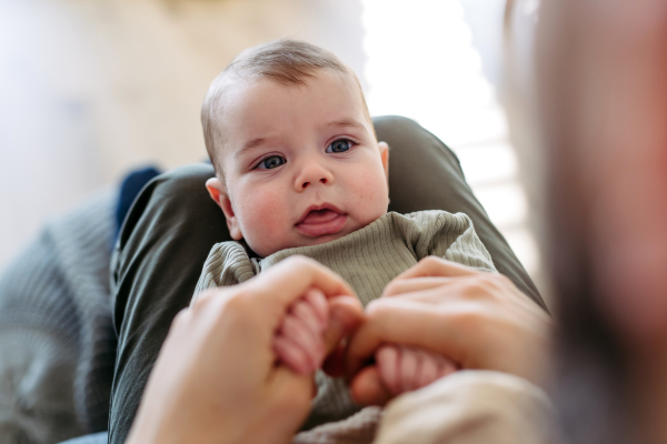 Portrait of a baby boy on his father's lap.