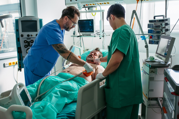 Medical team performing CPR and electric shock during cardiac arrest.