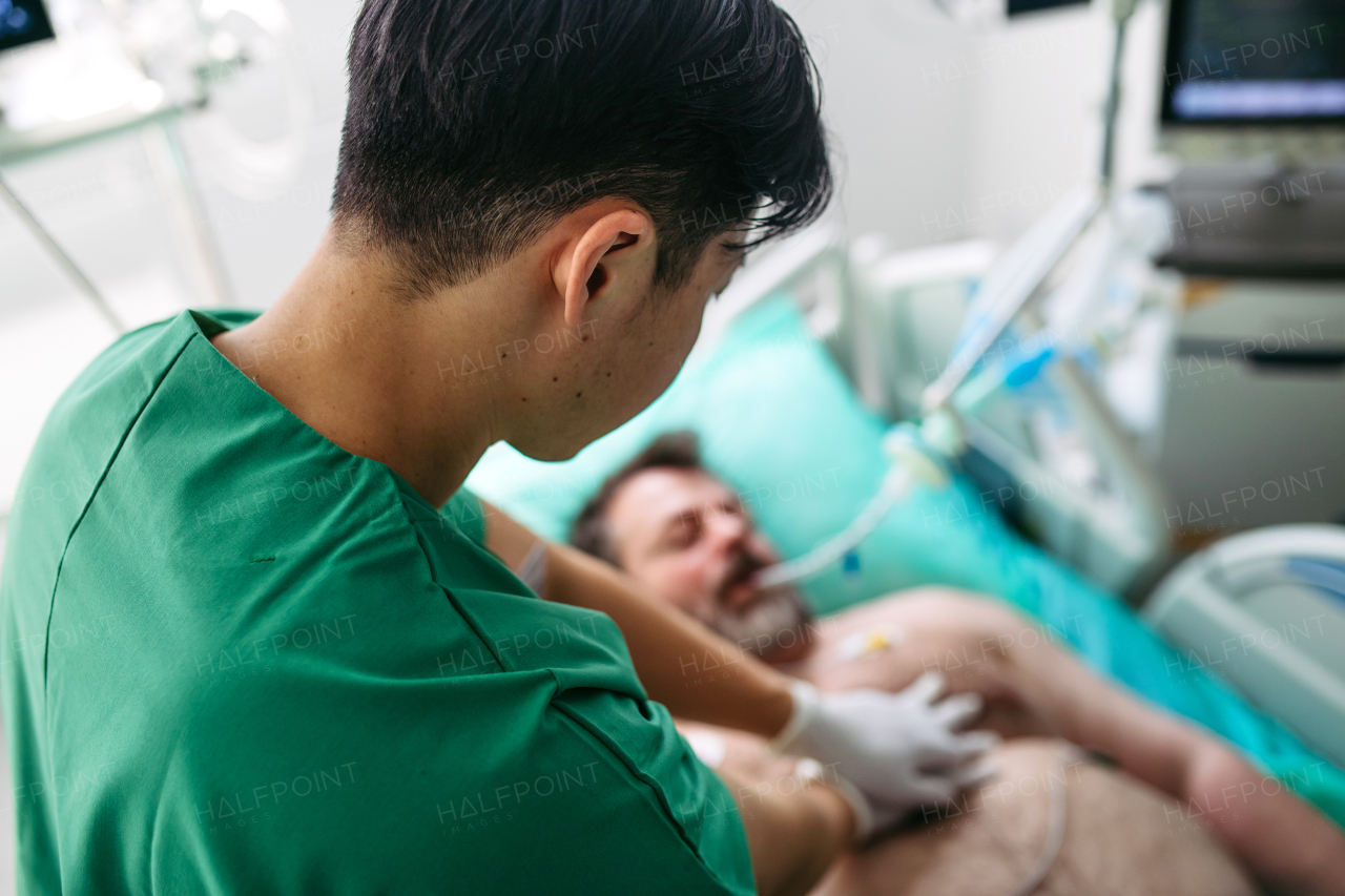 Medical team doing CPR on intubated patient in hospital.