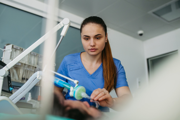 Nurse in emergency room, taking care of patient in ciritical condition.