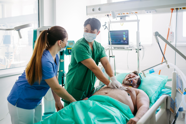 Hospital team saving intubated patient with cardiac arrest using CPR.