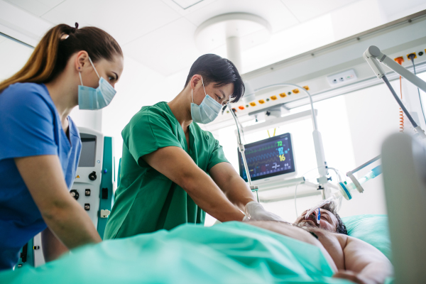 Hospital team saving intubated patient with cardiac arrest using CPR.