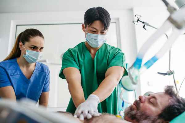 Hospital team saving intubated patient with cardiac arrest using CPR.