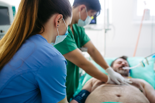 Hospital team saving intubated patient with cardiac arrest using CPR.